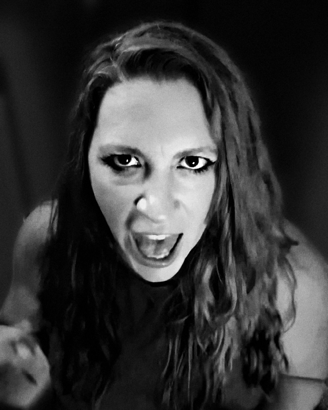 Black-and-white portrait of Meg Hudson singing